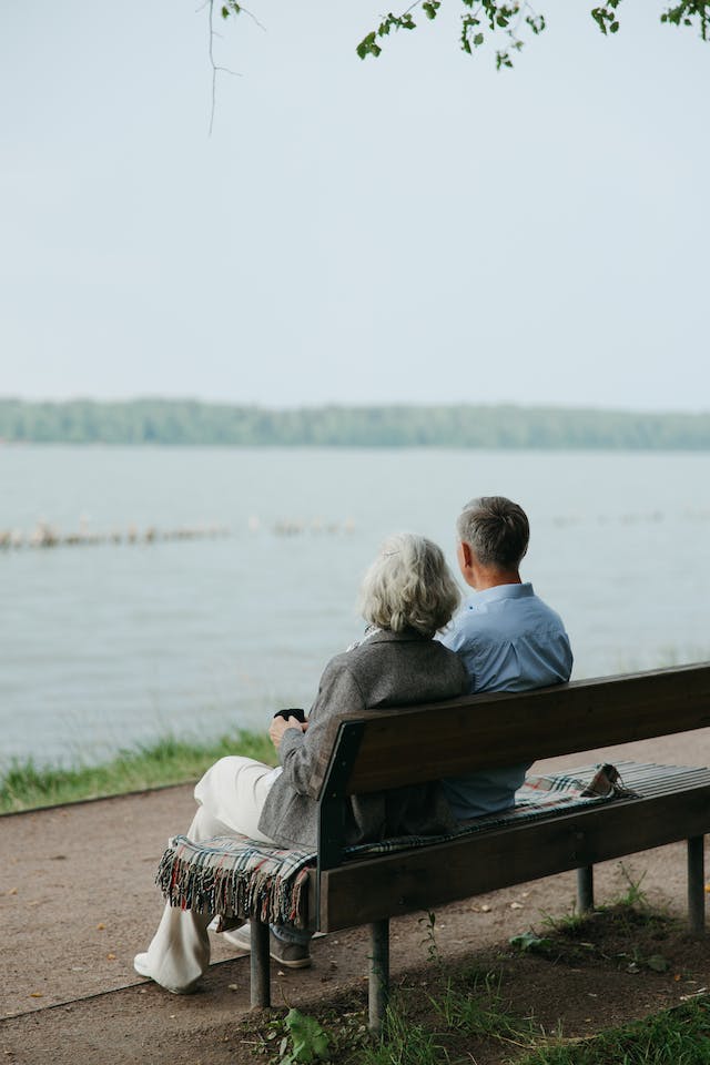 estate planning, image of couple sitting in a bench looking at body of water