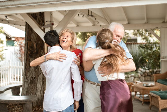 long-term inheritance distributions, image of grandparents hugging young adult grandchildren