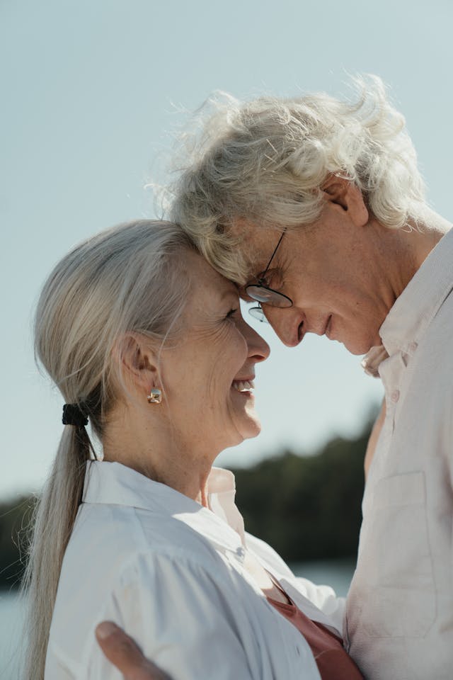 intentional estate planning, image of senior couple standing forehead to forehead smiling