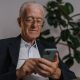 inheritance in a divorce, image of senior man in a sport jacket looking at a phone